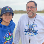 Jim and Tyrin at Camp Manitou smiling for a picture.
